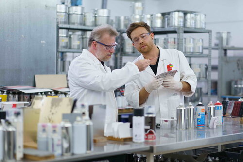 Chemistry lab assistants examine mixture