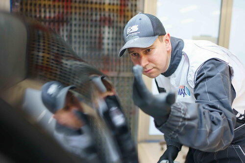 Application engineer inspects painted surface