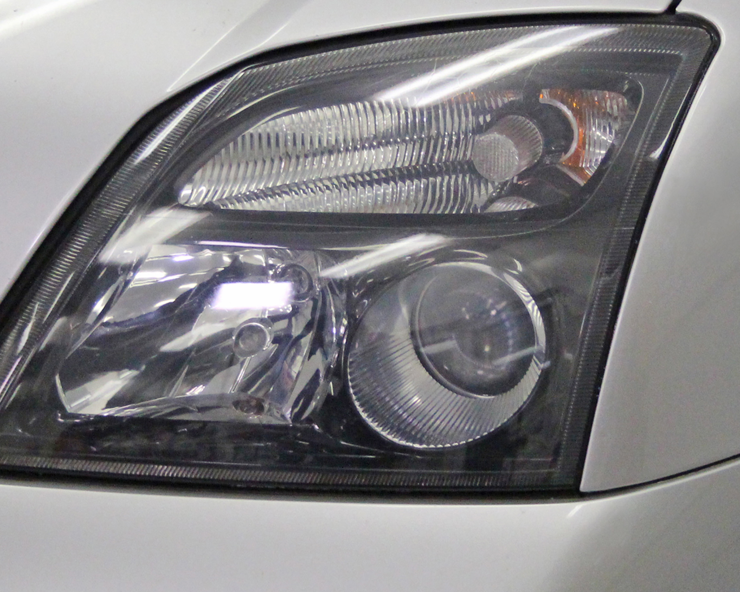 Headlight lens recoating